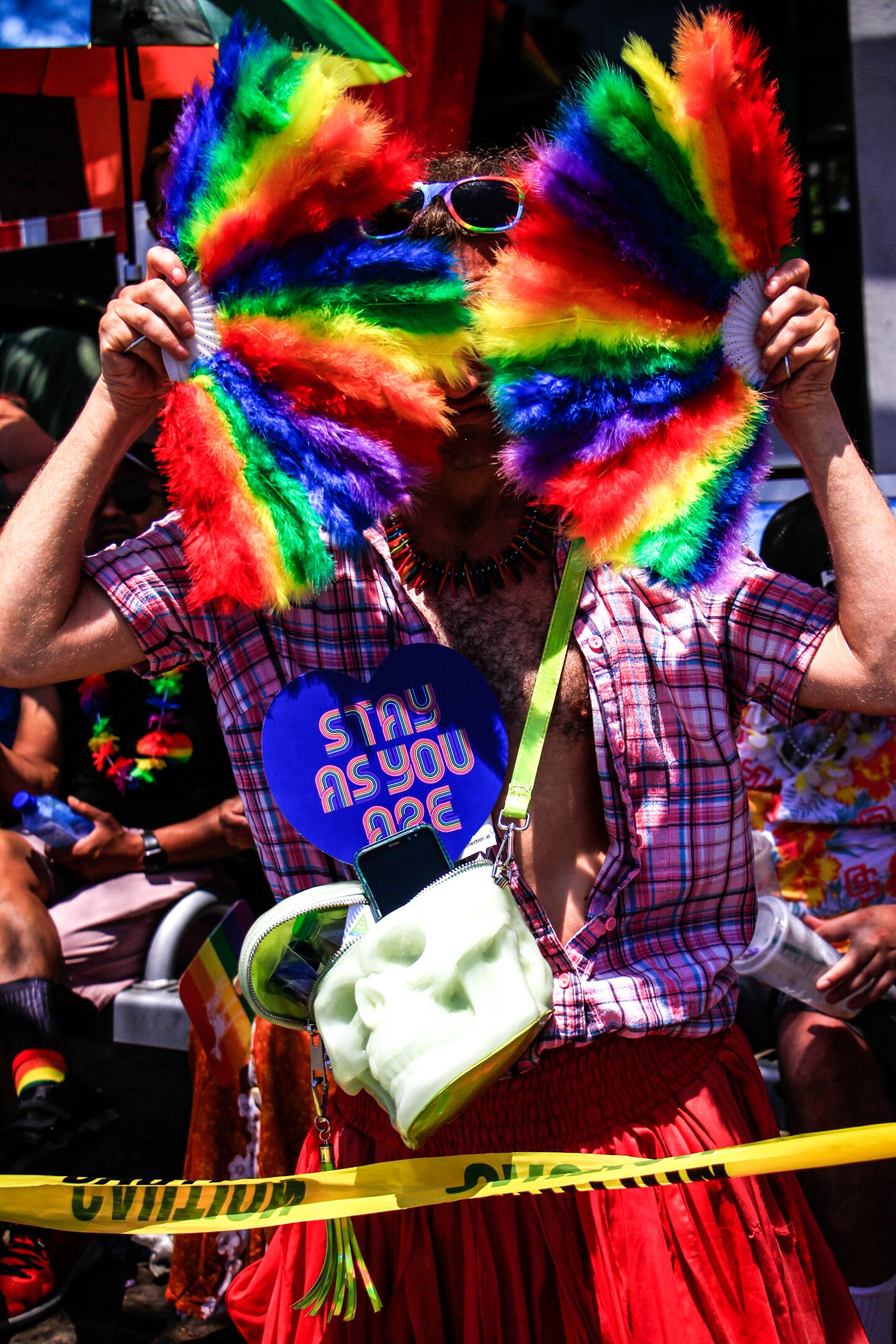 Parade attendee poses with colorful fans on July 15, 2023.