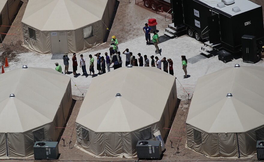 Children and workers are seen at a tent encampment on June 19, 2018 in Tornillo, Texas. The Trump administration is using the tent facility to house immigrant children separated from their parents.
