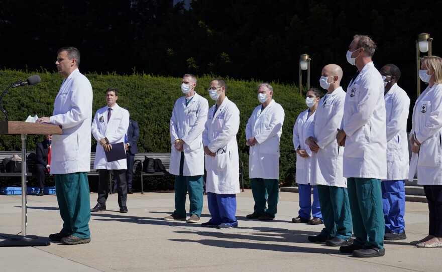 Dr. Sean Dooley briefs reporters at Walter Reed National Military Medical Center in Bethesda, Md. on Saturday. Trump was admitted to the hospital after contracting the coronavirus.