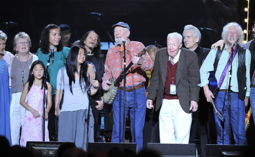 Pete Seeger (center) celebrates his 90th birthday surrounded by friends.
