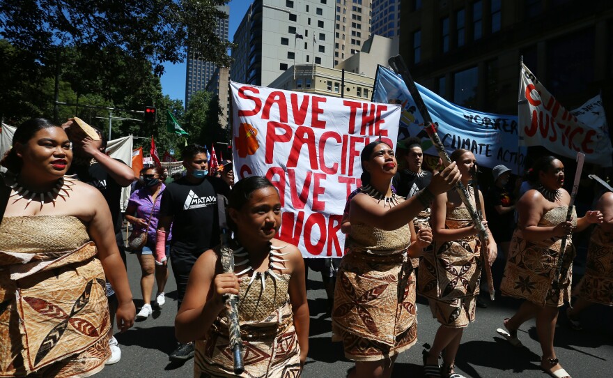 Climate activists march in Sydney, Australia, during a COP26 protest on Saturday that was one of several demonstrations held around the world.