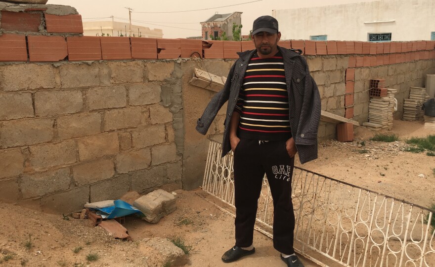 Jilan Abdul Kabir stands next to the spot where his cousin, Abdul Atti al-Kabir, was shot and killed by ISIS militants in a battle earlier this month in southern Tunisia, near the Libyan border.