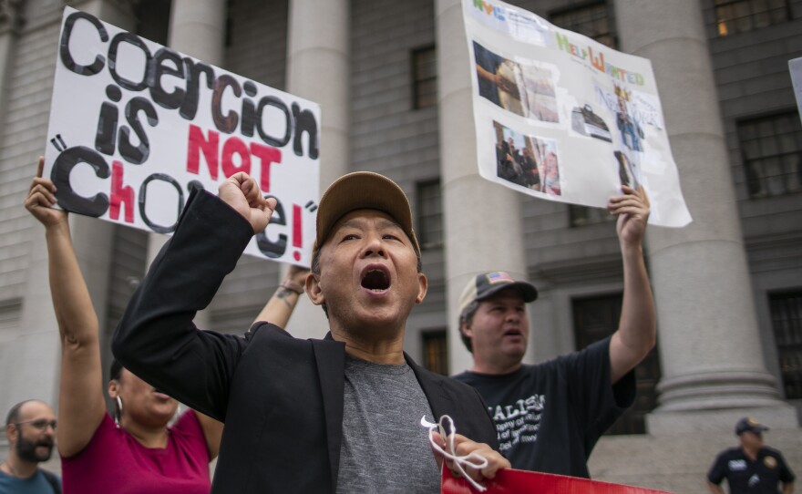People and teachers protest against COVID-19 vaccine mandates outside the Manhattan Federal Court Tuesday, Oct. 12, 2021, in New York.