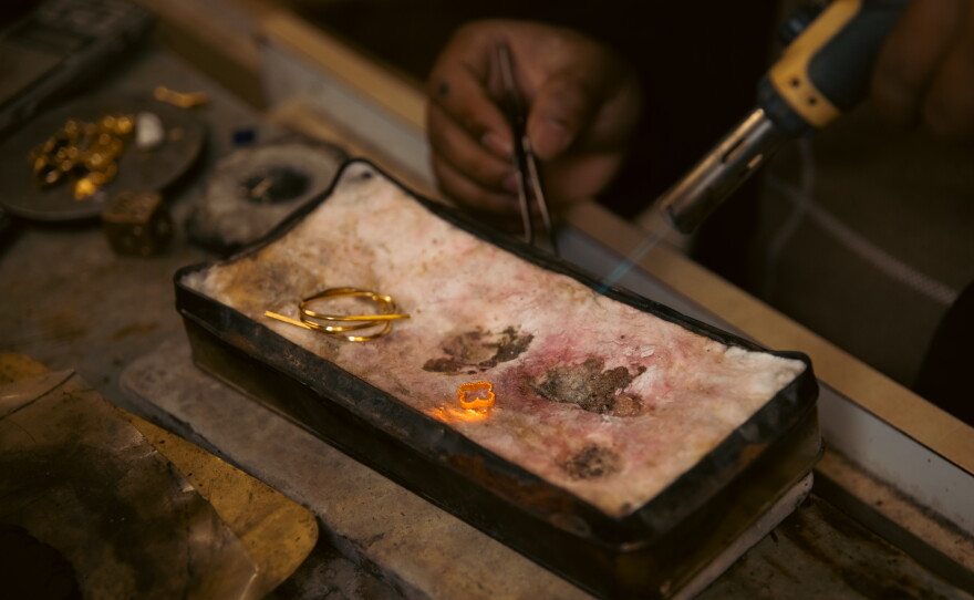 Binod Biswa, the co-owner of a jewelry shop in Harrisburg, Pa., produces and repairs gold pieces on April 16, 2025. He learned the craft from his uncle, who co-owns the store.