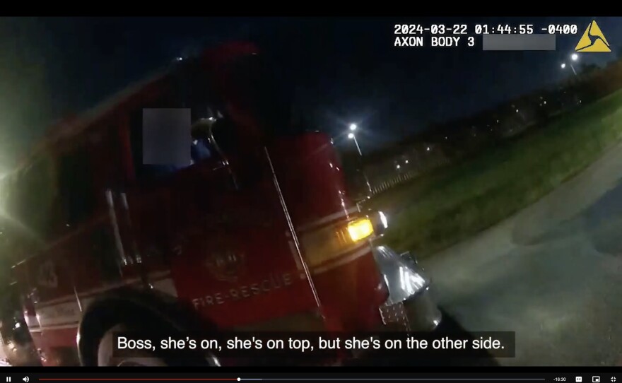 A screenshot from recently released body-worn camera footage shows a Fire-Rescue vehicle near the border fence.