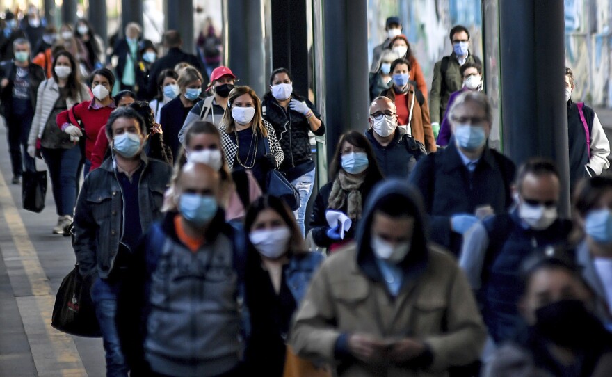 Commuters crowd Cadorna train station in Milan on Monday. Italy has begun stirring again, after a nearly two-month coronavirus shutdown, as restrictions on movement ease.