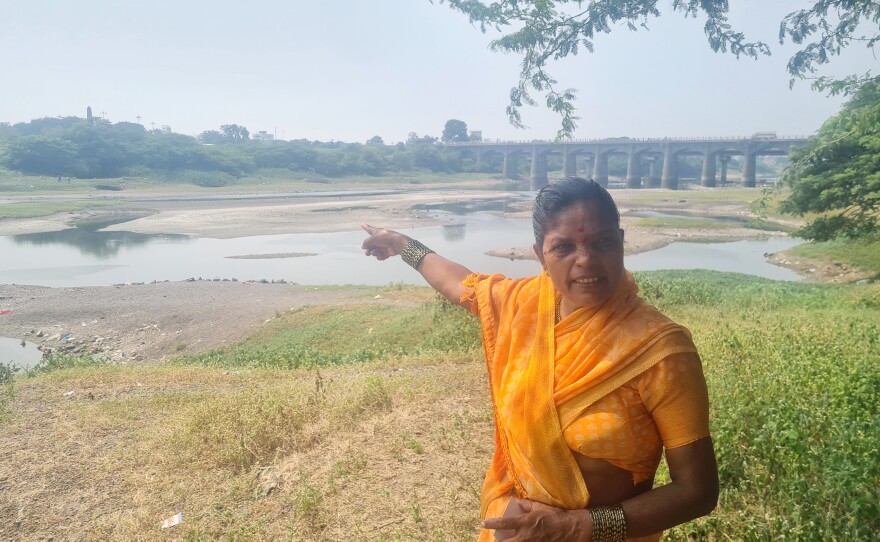Sangeeta Govind Kamble, former chief municipal official in Koregaon village, on the banks of the Bhima River in western India. Across the river, an obelisk monument commemorates the 1818 Battle of Bhima Koregaon. Riots broke out there on the 200th anniversary in 2018.