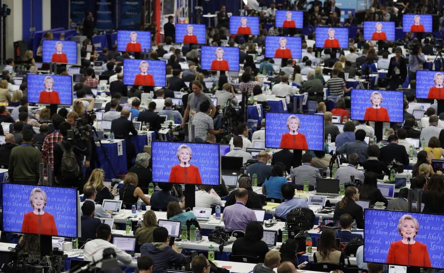 Hillary Clinton is seen on screens in the media center Sept. 26, during her debate with Donald Trump at Hofstra University in Hempstead, N.Y.