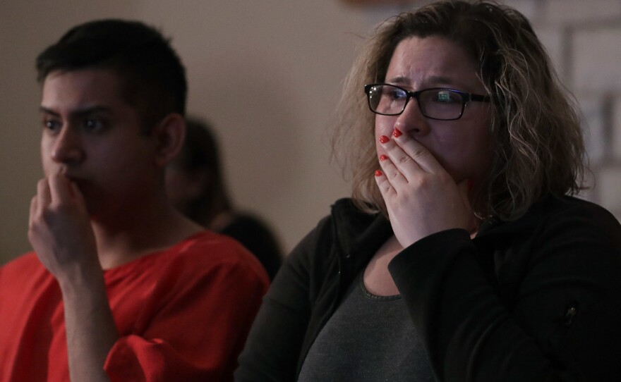 Angelica Magana, 34, a Deferred Action for Childhood Arrivals program recipient who was brought to the United State at the age of 8, and Victor Guzman, an undocumented resident, react to President Trump's remarks about his immigration policy during a State of the Union watch party Tuesday in Chicago.