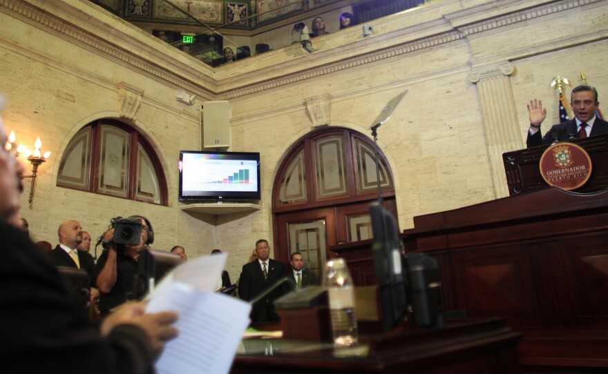Gov. Alejandro Garcia Padilla (right) delivers his budget plan for Puerto Rico's upcoming fiscal year at the Capitol in San Juan on April 30. Legislators rejected his call to raise taxes as way to compensate for the island's rampant tax evasion.