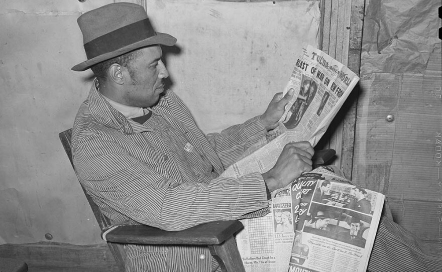 Pomp Hall, negro sharecropper, reading the newspaper to which he subscribes. Creek County, Okla. February 1940.