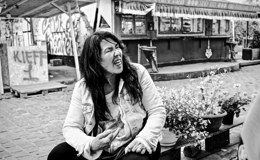 Bidstrup titled the above image pairing <em>Conquest.</em>Bottom image: A Greenlandic woman nicknamed 'Lucifer' gives the finger after a friend mocks her outside The Starship house in Christiana, Copenhagen where Greenlanders are known to live.<em></em>