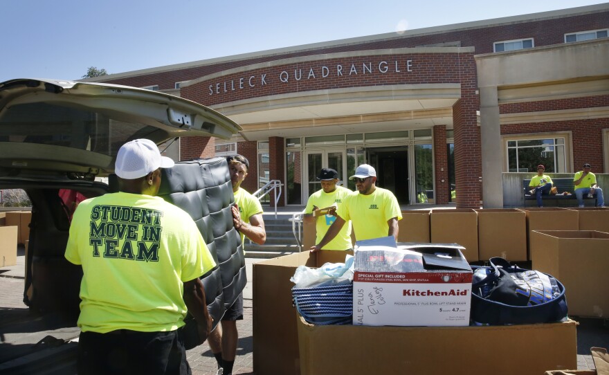 Workers help students move in to Selleck Hall, at the University of Nebraska–Lincoln.