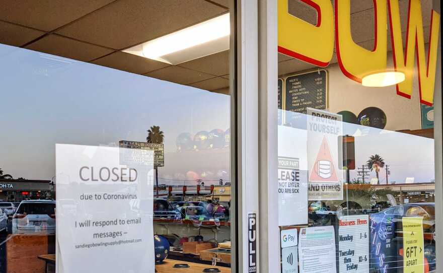 A "Closed due to Coronavirus" sign posted on the door of San Diego Bowling Supply in Kearny Mesa, Jan. 8, 2021.