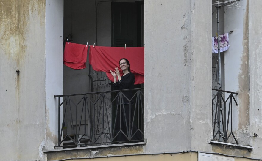 From windows and balconies in Rome, Italians cheered and made music to thank health workers. This photo was taken on March 14, 2020.