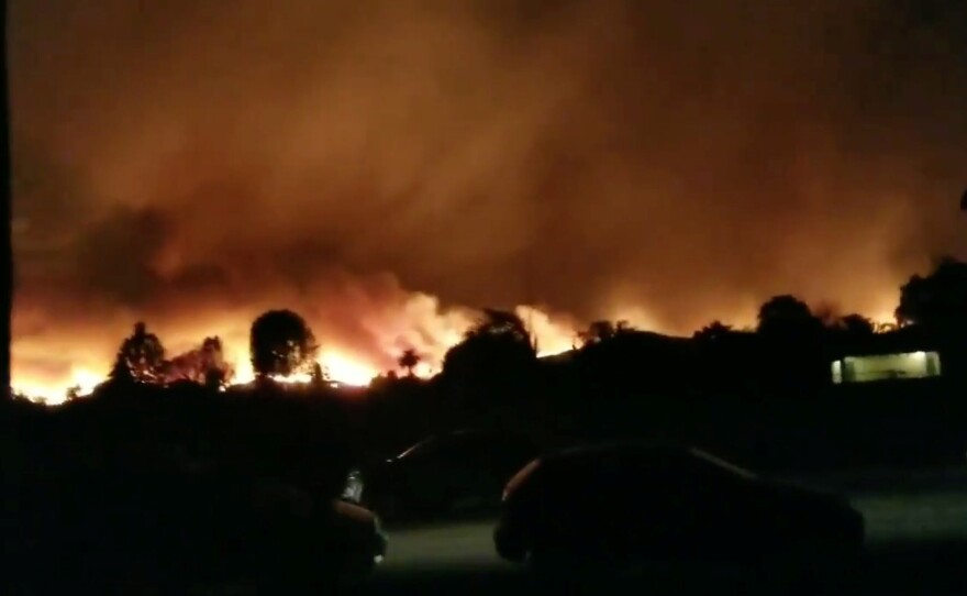 A wildfire blazes in Ventura County, Calif., on Tuesday in this still image taken from social media video.