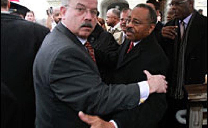 Illinois U.S. Senate appointee Roland Burris (right) is escorted by Senate Sergeant-at-Arms Terrance Gainer (left) while leaving the U.S. Capitol on Tuesday.