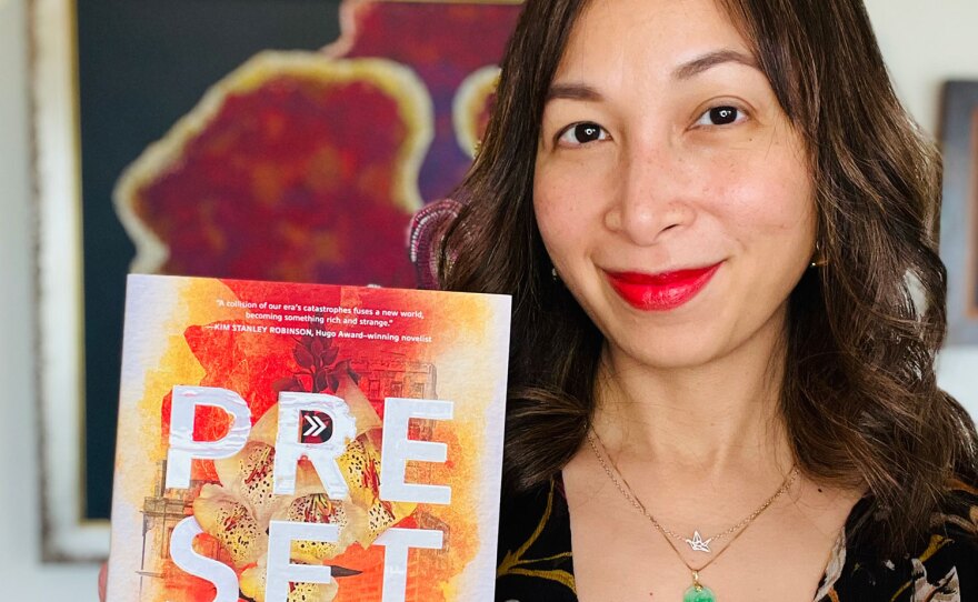 Author Sarina Dahlan is shown with her book, "Preset" in an undated photo.