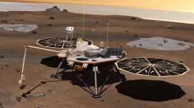 NASA's Phoenix Mars Lander monitors the atmosphere overhead and reaches out to the soil below in this artist's depiction of the spacecraft fully deployed on the surface of Mars.
