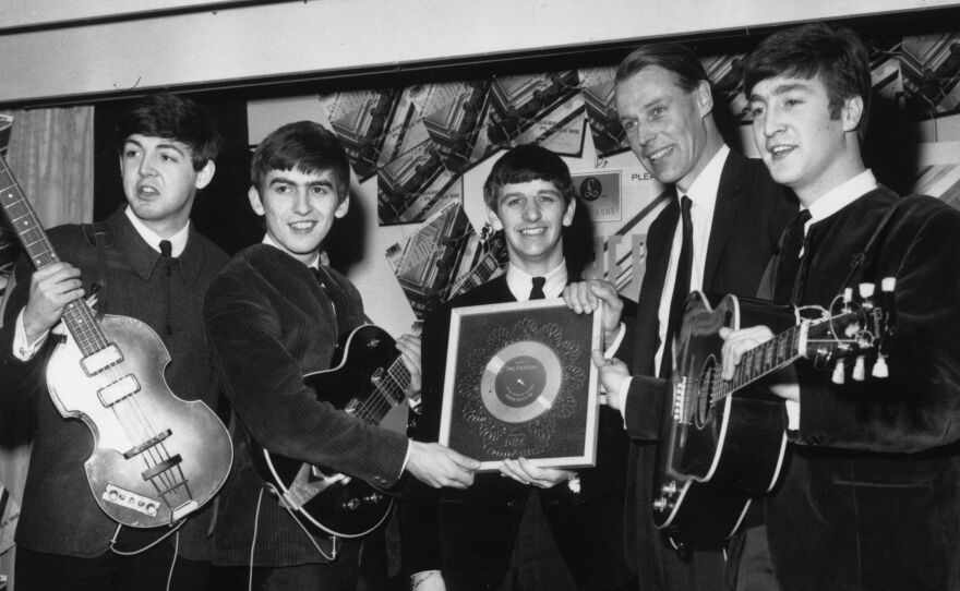 The Beatles in 1963 with their first silver record. From left: Paul McCartney, George Harrison, Ringo Starr, producer George Martin and John Lennon.