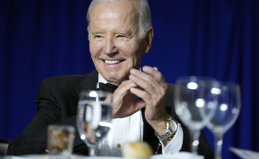 President Joe Biden claps as comedian Roy Wood Jr., a correspondent for <em>The Daily Show</em>, speaks during the White House Correspondents' Association dinner at the Washington Hilton in Washington, D.C., on Saturday.