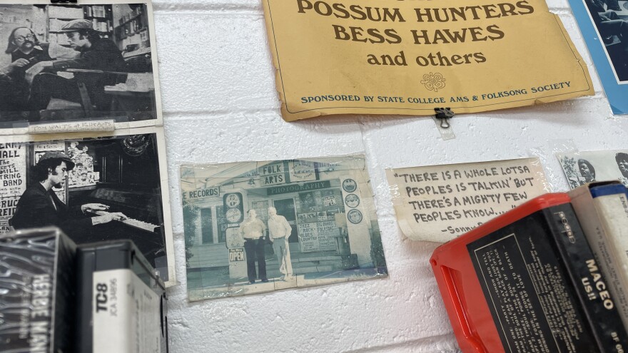 Photos, clippings and posters adorn the walls at Folk Arts Rare Records in City Heights, shown on Dec. 12, 2025. Folk artist Tom Waits is shown in two photos at left, including with Lou Curtiss in the top left corner.