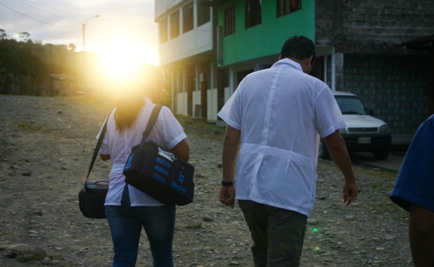 Health workers head to the next patient.