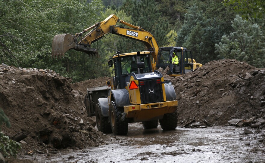 Heavy equipment works to clear a Jamestown road after a landslide covered it with more than 20 feet of mud.