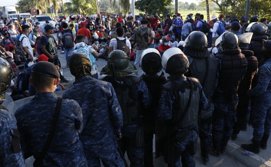 Guatemala's military stops migrants who are part of a caravan from Honduras hoping to reach the United States after they crossed the border in Puerto Barrios, Guatemala, on Jan. 15.
