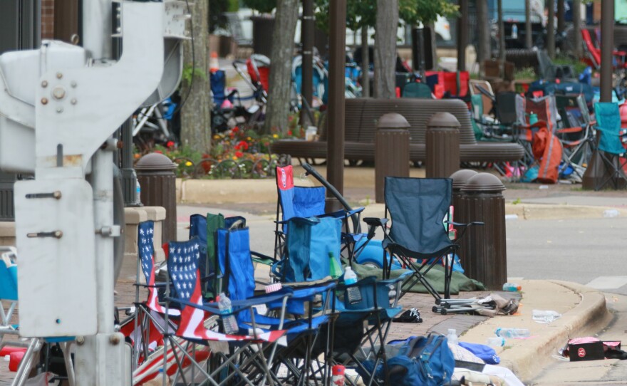 Police detained a suspect in connection with Monday's parade shooting, the aftermath of which is pictured here.