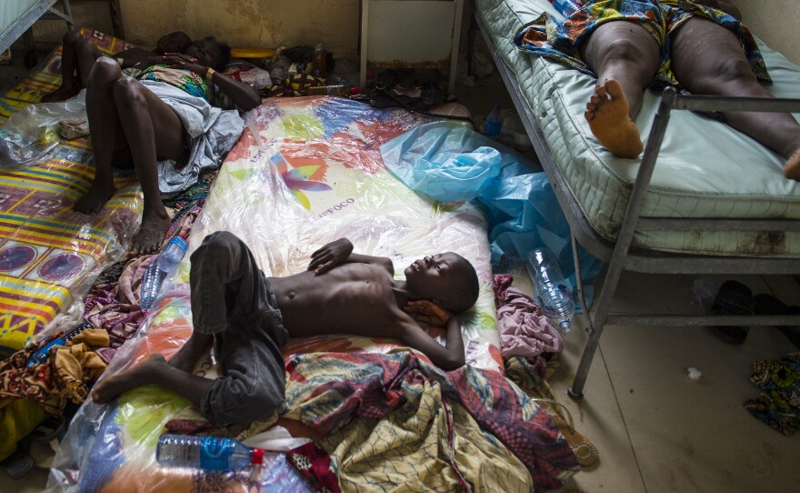 A boy lies on a mattress on the floor of Redemption Hospital, a h holding center for Ebola patients. The photo was taken on Sept. 20 in Monrovia, Liberia.
