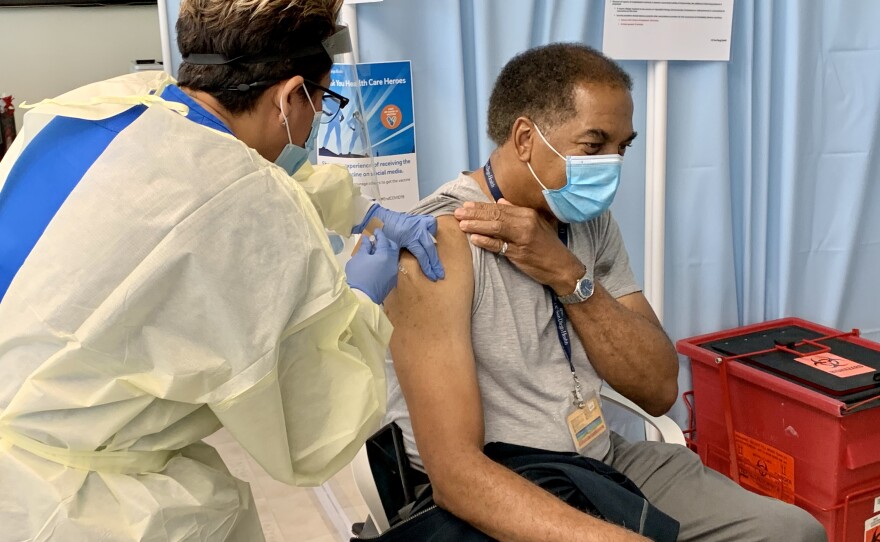 Carl Solomon, Senior Director of Environmental Services at UC San Diego Health gets a COVID-19 vaccine, Dec. 16, 2020.