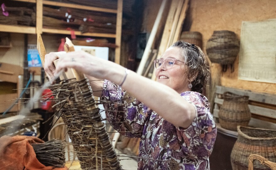 MaddyChristine Hope Brokopp weaves the bottom of a burial tray. Brokopp enlisted her friends to weave her tray after a cancer diagnosis.