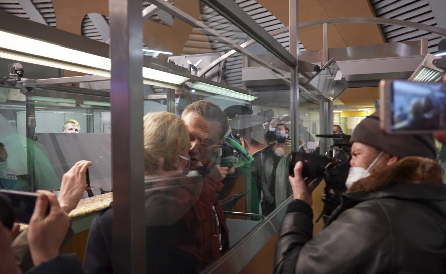 Alexei Navalny kisses his wife Yulia as he is detained by police at the passport control after arriving at Sheremetyevo airport outside Moscow on Jan. 17, 2021.