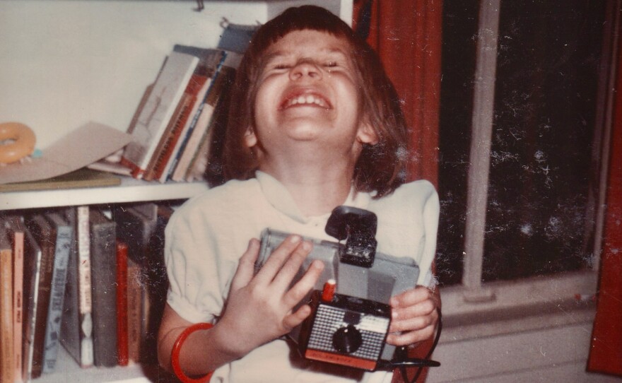 Girl hugging her new Polaroid Square Shooter.