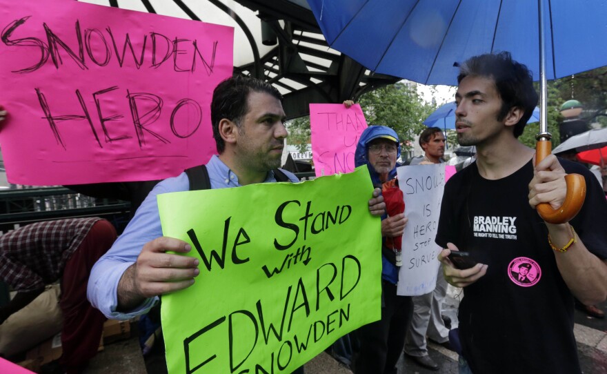 Demonstrators hold signs supporting Edward Snowden in New York's Union Square Park, on Monday. Snowden, who says he worked as a contractor at the National Security Agency and the CIA, gave classified documents to reporters, making public two sweeping U.S. surveillance programs and touching off a national debate on privacy versus security.