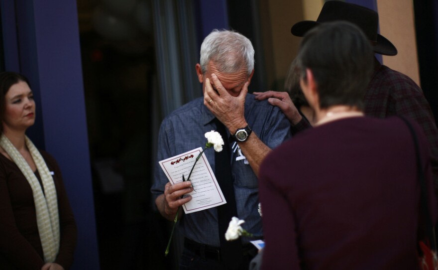 Ross Zimmerman, father of Gabe Zimmerman, mourns at his son's memorial service in Tucson, Arizona Jan. 17.