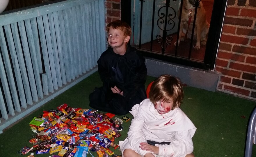 Jake (left) and Will (right) dump out their loot after trick-or-treating.