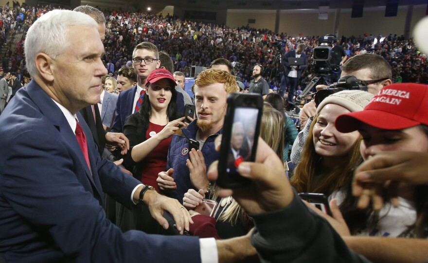 Republican vice presidential nominee Mike Pence, left, shakes the hands of supporters after a speech at Liberty University in Lynchburg, Va., on Oct. 12.