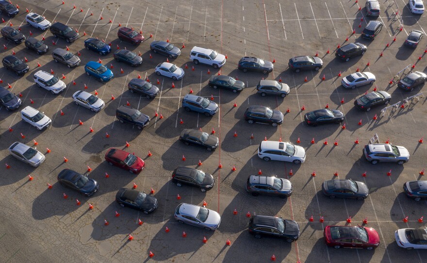 In an aerial view from a drone, cars line up at Dodger Stadium for COVID-19 testing in Los Angeles, California.