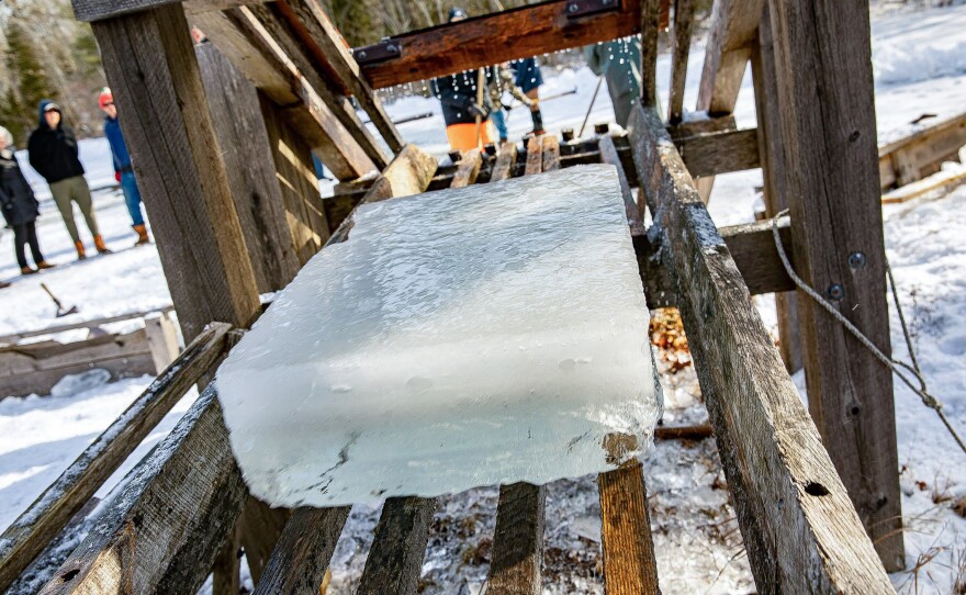 A block of ice glides down the ramp.