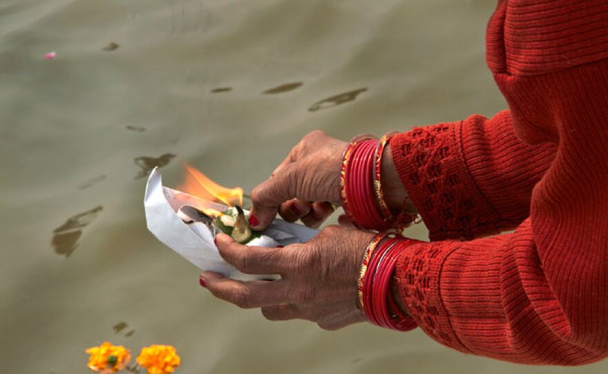 Pilgrims lighting candles during the Kumbh Mela.