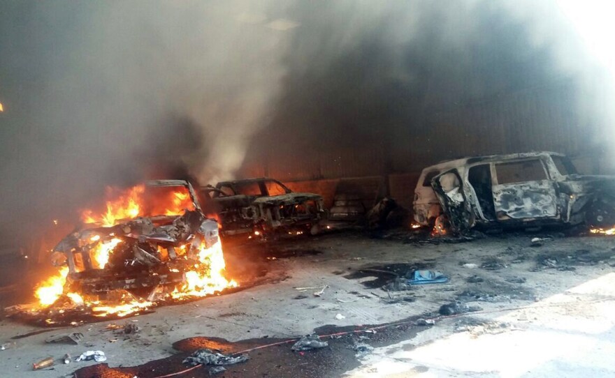 Vehicles burn, that authorities say caught fire during a gunbattle, in a warehouse at Rancho del Sol, near Ecuanduero, in western Mexico, on Friday. At least 43 people died Friday in what authorities described as a fierce, three-hour gunbattle between federal forces and suspected drug gang gunmen.