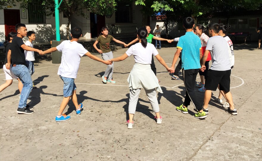 Students connect into a "chemical reaction" during an unconventional game of tag.