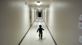 An asylum-seeking boy from Central America runs down a hallway after arriving at a shelter in San Diego, December 2018.