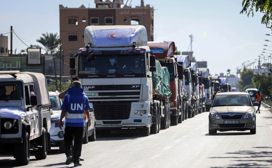 The first trucks carrying humanitarian aid head to Deir Al-Balah after crossing from Egypt into the Gaza Strip in Rafah, on Oct. 21, 2023.
