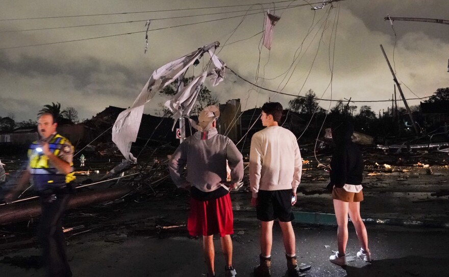 Authorities survey damage in the Lower 9th Ward on Tuesday in New Orleans.