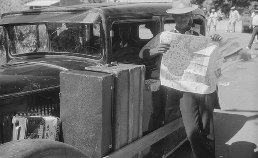 Granville Clarke, Florida migratory agricultural worker studying road map before leaving Elizabeth City with his crew. They are going to Bridgeville, Delaware to work in a cannery. (undated photo)