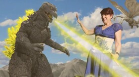 Godzilla 2000 and Cinema Junkie Beth Accomando battle it out on the Comic-Con floor at Toho's debut booth at the pop culture convention.