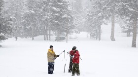 Frank Gehrke, right, chief of the California Cooperative Snow Surveys Program for the Department of Water Resources, prepares to do the first sample of the second manual snow survey of the season at Phillips Station near Echo Summit, Feb. 2, 2016. Gehrke was accompanied by Michael Jarred, left, a consultant with Assembly Natural Resources Committee, and Kasey Schimke, of the Department of Water Resources. 